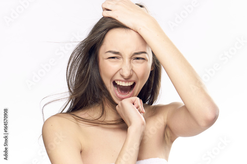 Young beautiful woman on white isolated background screams  portrait