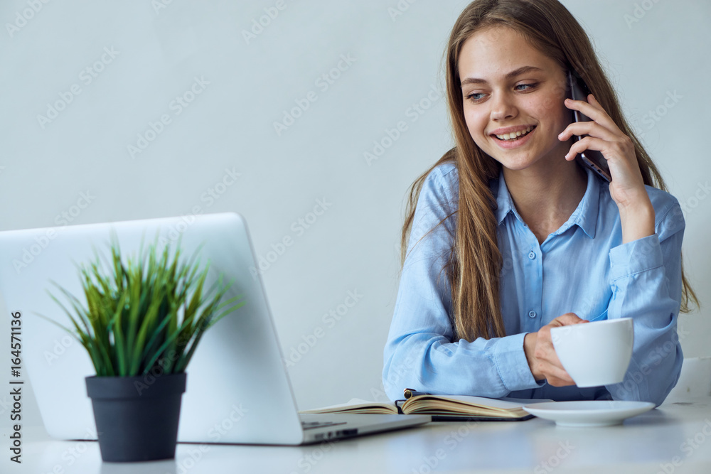 Young beautiful woman working at computer in office Young beautiful woman working at computer in office