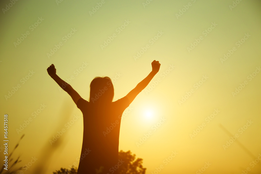Silhouette of woman praying over beautiful sky background Silhouette of woman praying over beautiful sky background