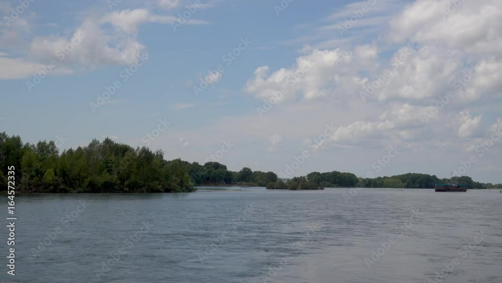 View of the Irtysh River, clouds in the blue sky and trees. The Irtysh River is a river in Russia, China, and Kazakhstan. 4k prores video View of the Irtysh River, clouds in the blue sky and trees. The Irtysh River is a river in Russia, China, and Kazakhstan. 4k prores video