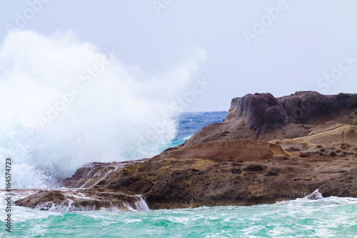 Big waves crashing against of the rocks.