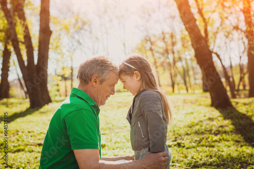 Little girl with mature grandfather