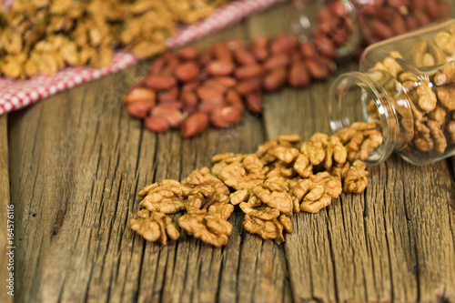 Mix of nuts in the glass jars , on the table.