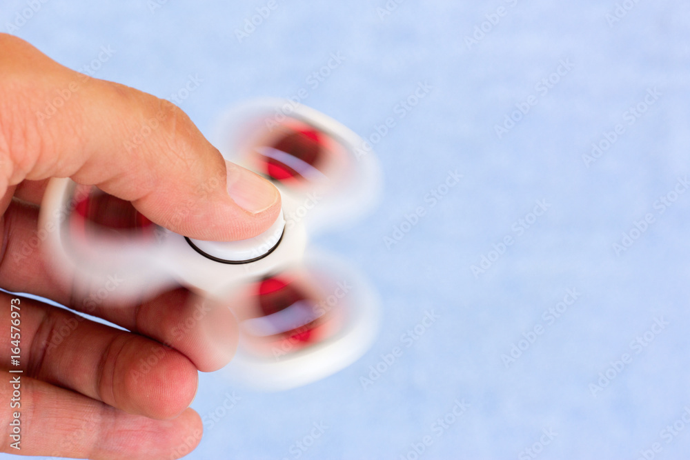 Virus toy spinner for children and adults. Antistress toy spinning in the hands on the bearings. Copy space for text