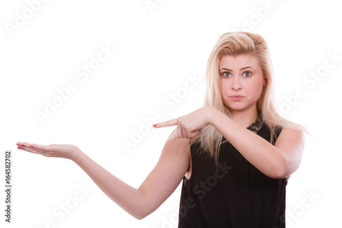 Blonde woman pointing with hands at copyspace