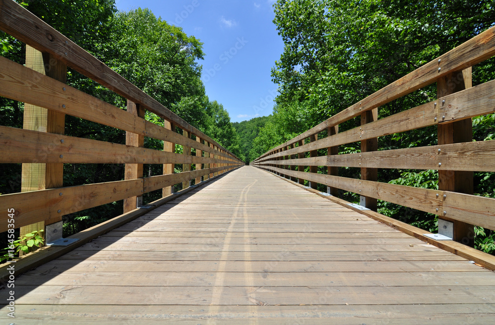 Wooden trestle bridge on the Virginia Creeper Trail in the United States, wildly popular with cyclists