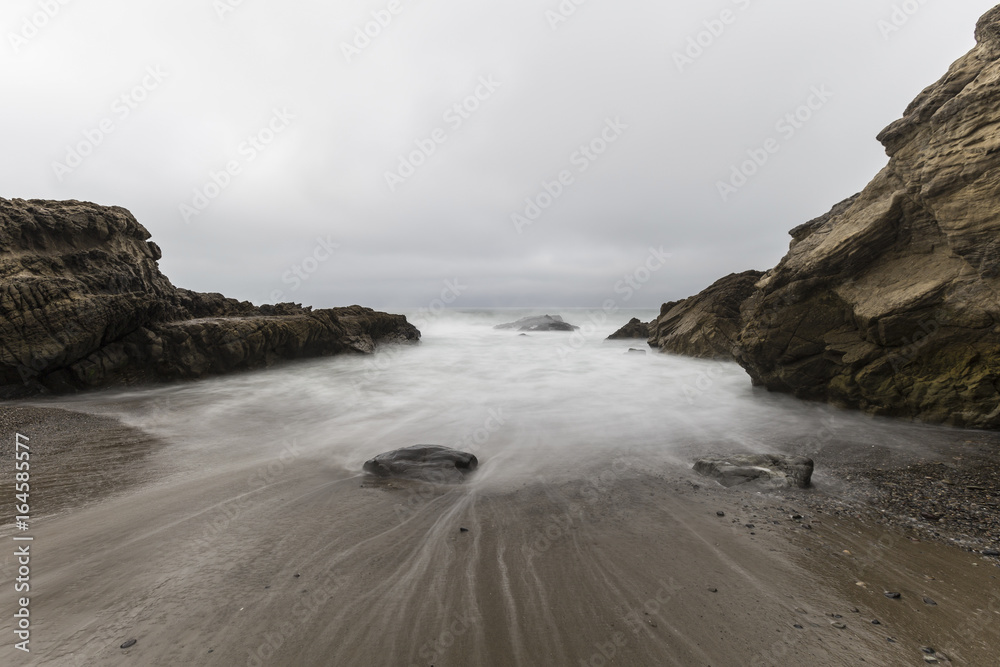 Rocky cove with motion blurred water at Leo Carrillo State Beach in Malibu, California. Rocky cove with motion blurred water at Leo Carrillo State Beach in Malibu, California.