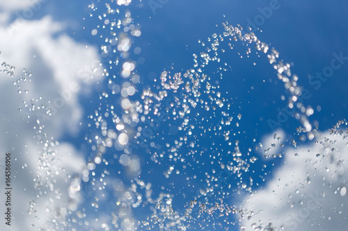 Spray of a fountain against the sky.