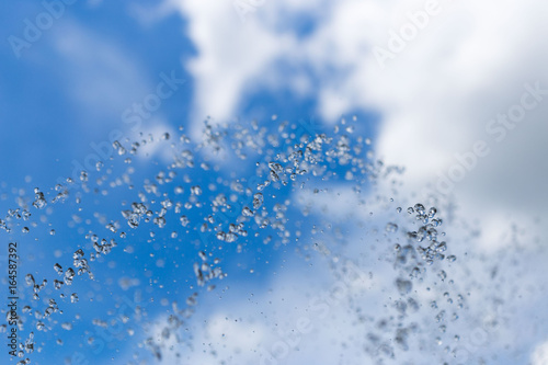 Spray of a fountain against the sky.