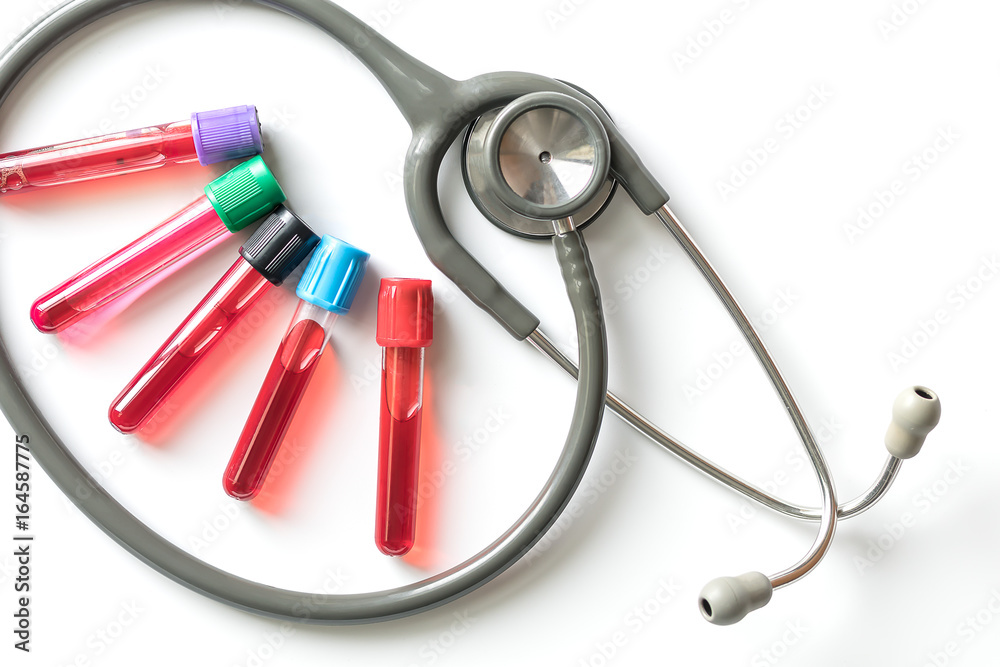 Blood test tube and stethoscope on white background. Blood test tube and stethoscope on white background.