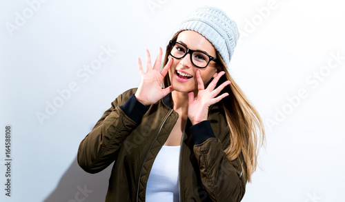 Hipster girl wearing glasses and hat on a white background