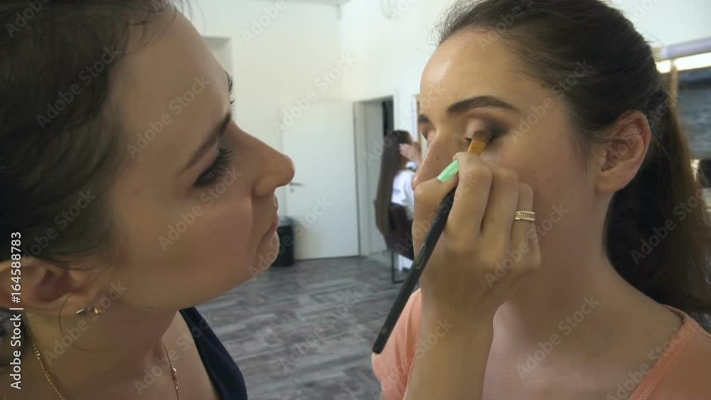 Professional make-up artist making face makeup art. Make up and fashion concept Professional make-up artist making face makeup art. Make up and fashion concept