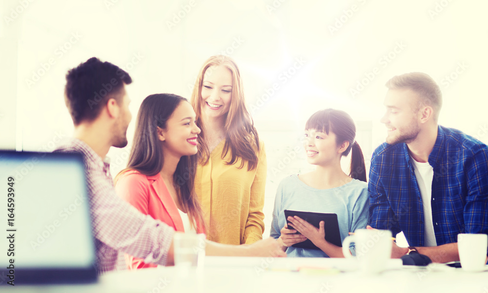 happy creative team or students working at office