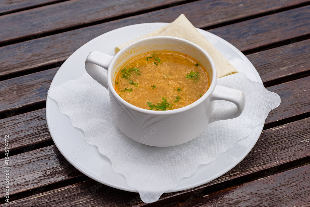 Lemongrass soup in white cup. Mexican food. Top view Lemongrass soup in white cup. Mexican food. Top view