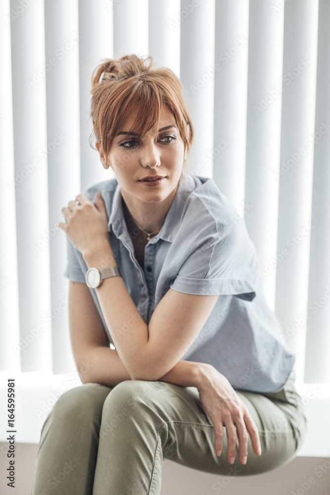 Portrait of beautiful casual ginger Caucasian woman looking.