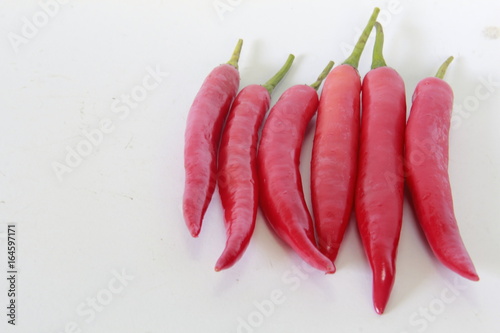 Pepper is a spicy food. Several chilies on a white background.