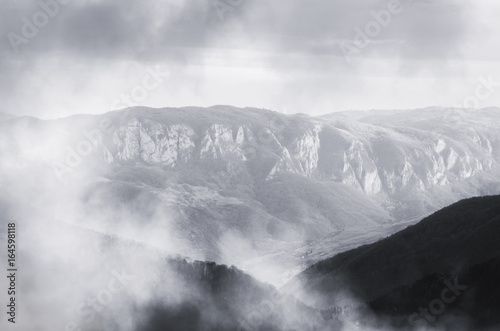 fantasy landscape with mountains and hills in fog