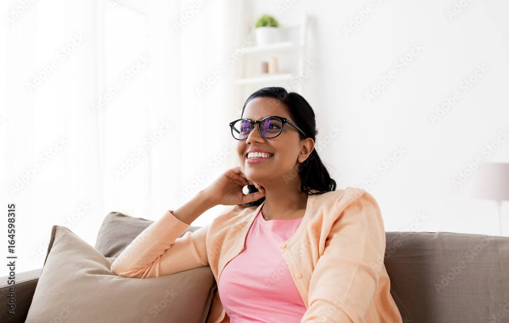 happy smiling young woman sitting on sofa at home happy smiling young woman sitting on sofa at home