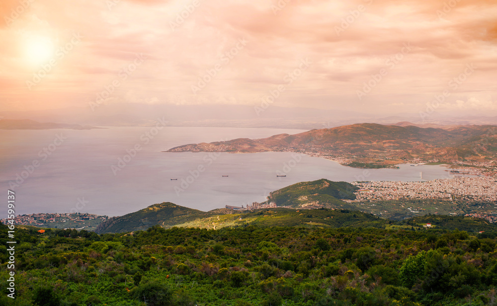 Fototapeta premium Panorama of the Greek city of Volos at sunset. Volos Greece. View from the mountain on the Volos