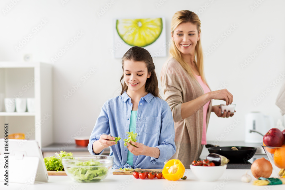 happy family cooking salad at home kitchen