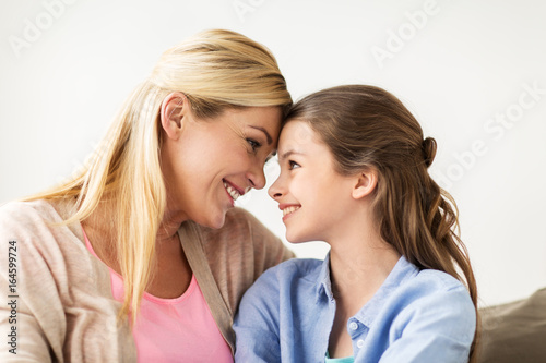 happy smiling family of girl and mother at home