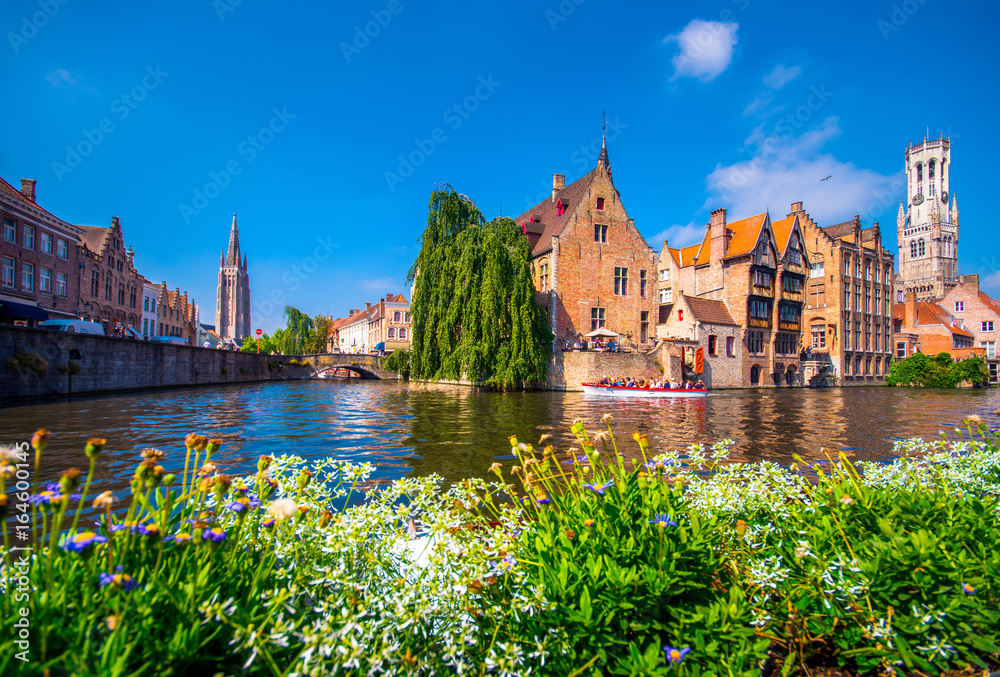 View from the Rozenhoedkaai in Brugge with the Perez de Malvenda house and Belfort van Brugge in the background in day light - obrazy, fototapety, plakaty 