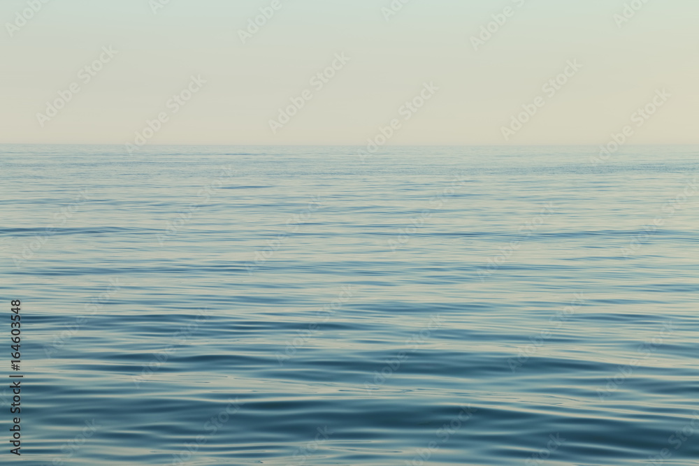 Calm sea surface. Seascape in early morning hours under clear skies. Calm sea surface. Seascape in early morning hours under clear skies.