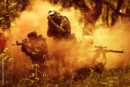 Officers on fire amidst smoke photo