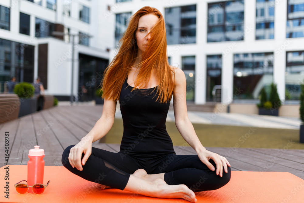 Model sits in lotus pose Model sits in lotus pose
