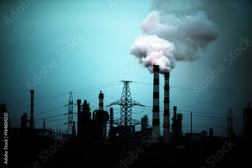 Industrial landscape, pipes and smoke, oil refinery dark background