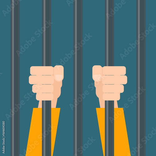 hands of prisoner behind bars.