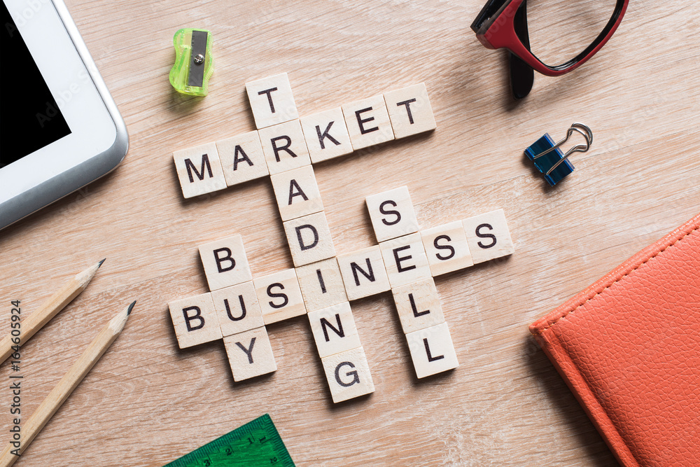 Conceptual business keywords on table with elements of game making crossword Conceptual business keywords on table with elements of game making crossword