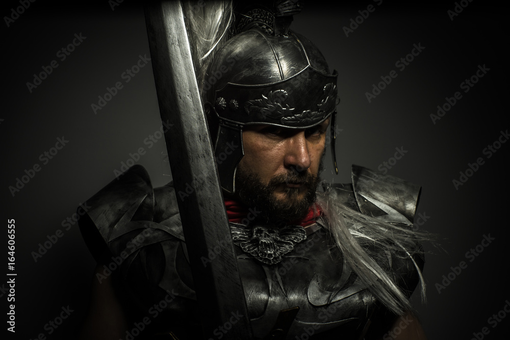 Gladiator, Roman centurion with armor and helmet with white chalk, steel sword and long red cape