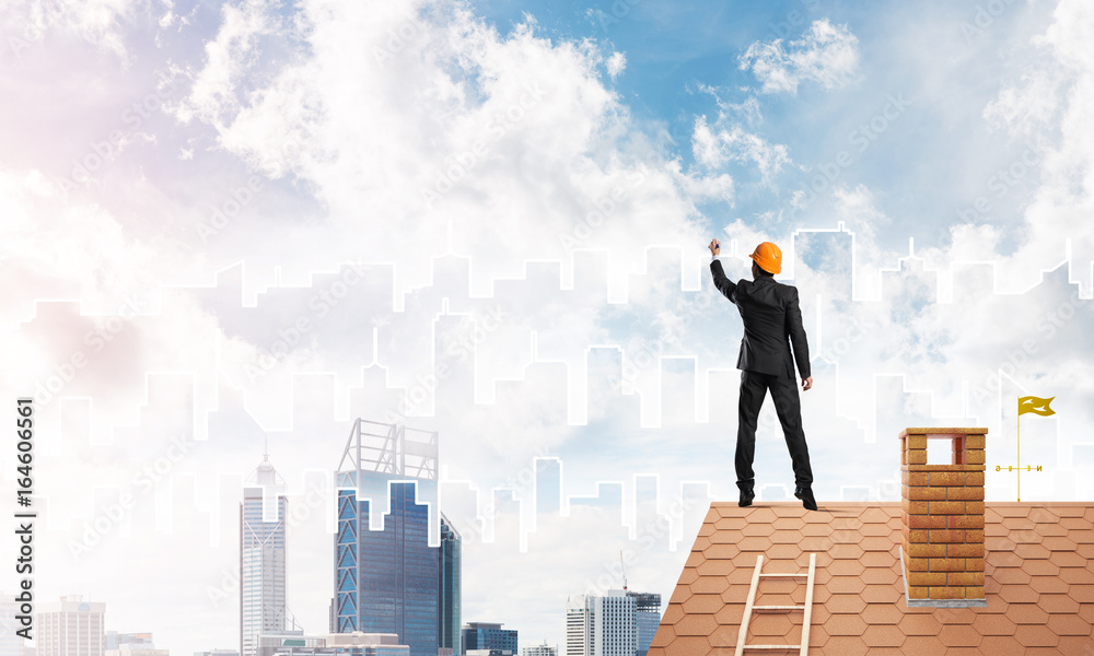 Man architect draw silhouette of modern city on blue sky. Mixed media Man architect draw silhouette of modern city on blue sky. Mixed media