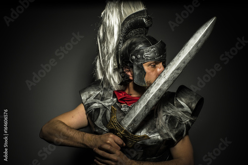 Fotografie, Obraz Legionnaire, Roman centurion with armor and helmet with white chalk, steel sword