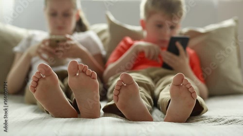 Boy and girl using app on smart phone. 