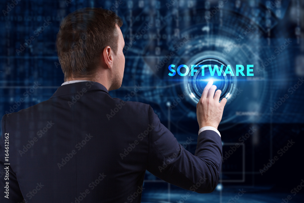 Business, Technology, Internet and network concept. Young businessman working on a virtual screen of the future and sees the inscription: Software Business, Technology, Internet and network concept. Young businessman working on a virtual screen of the future and sees the inscription: Software