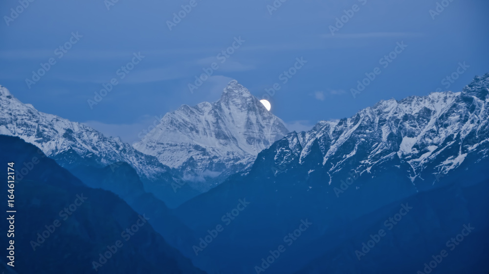 Moonrise from behind the Nandadevi Peak, the second-highest mountain in India as seen from Auli in Uttarakhand, India