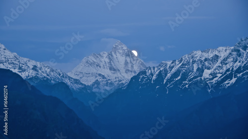 Moonrise from behind the Nandadevi Peak, the second-highest mountain in India as seen from Auli in Uttarakhand, India