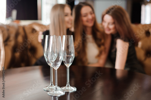 empty glasses of champagne on the background of the girls