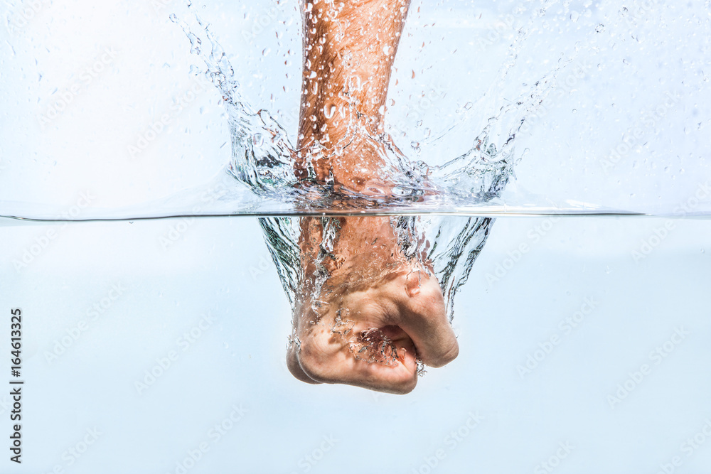 Male fist through the water
