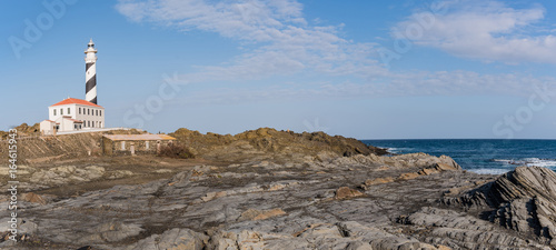 Rocky landscape with favaritx lighthouse. Menorca, Spain photo