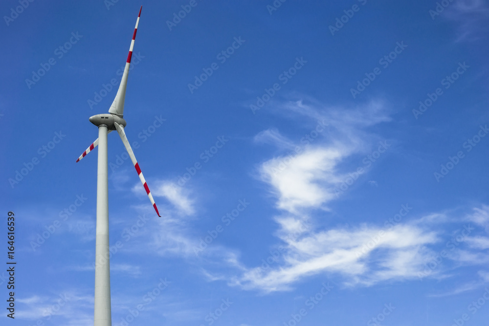 Windmill against cloudy sky with copyspace Windmill against cloudy sky with copyspace