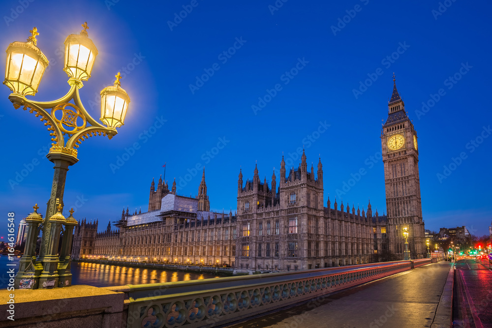 London, England - The Big Ben and the Houses of Parliament with street lamp taken from westminster bridge at dusk
