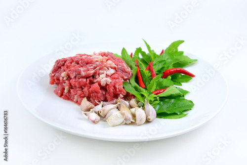 Ingredients of spicy fried meat with basil leaves.
