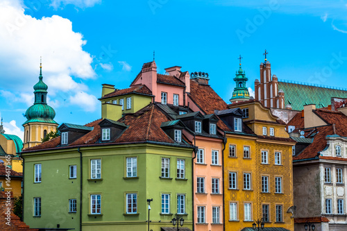 Colorful houses in the old town in Warsaw at the castle square. Sunny summer day with a blue sky. Horizontal photo.