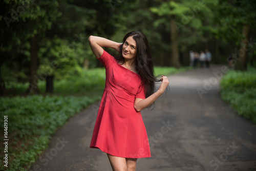 Attractive brunette woman wearing red short dress © ilyaska