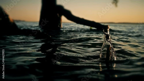 A bottle with a note swings on the waves