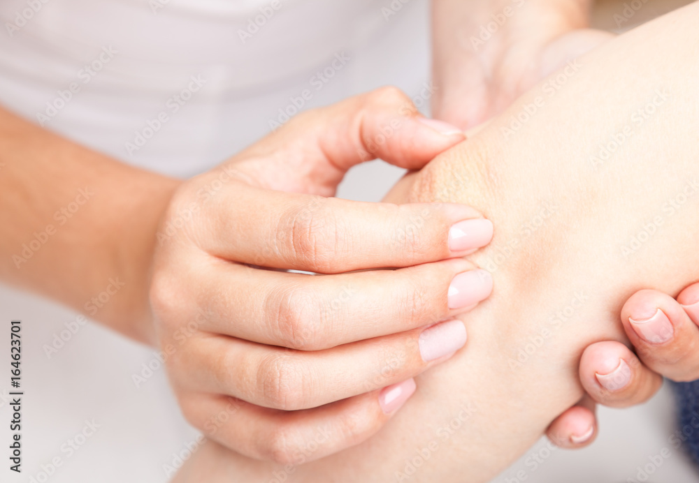 Woman receiving osteopathic treatment of her elbow Woman receiving osteopathic treatment of her elbow