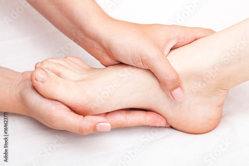 Woman receiving osteopathic treatment of her foot joint © Dmitry Naumov